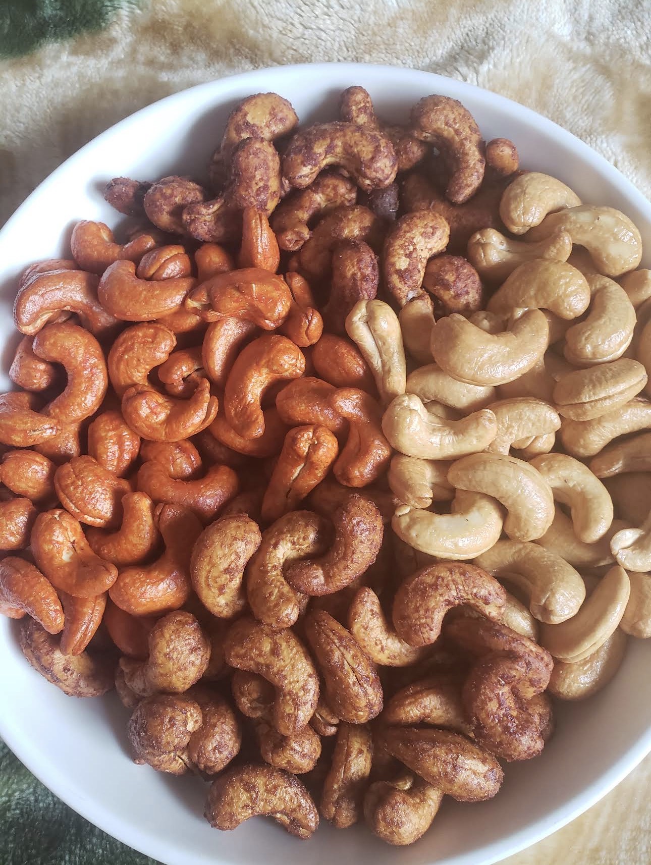 Plate of glazed, smoked, and natural roasted cashews